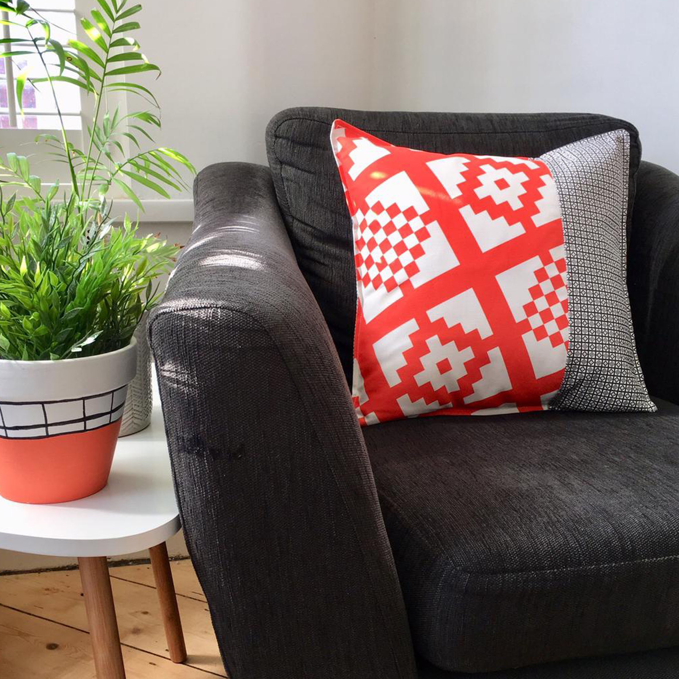 tangerine and charcoal geo print cushion